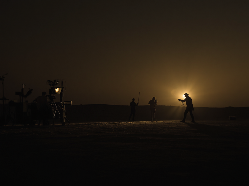 Night desert film shoot lit against the dunes — Abu Dhabi film servicing.