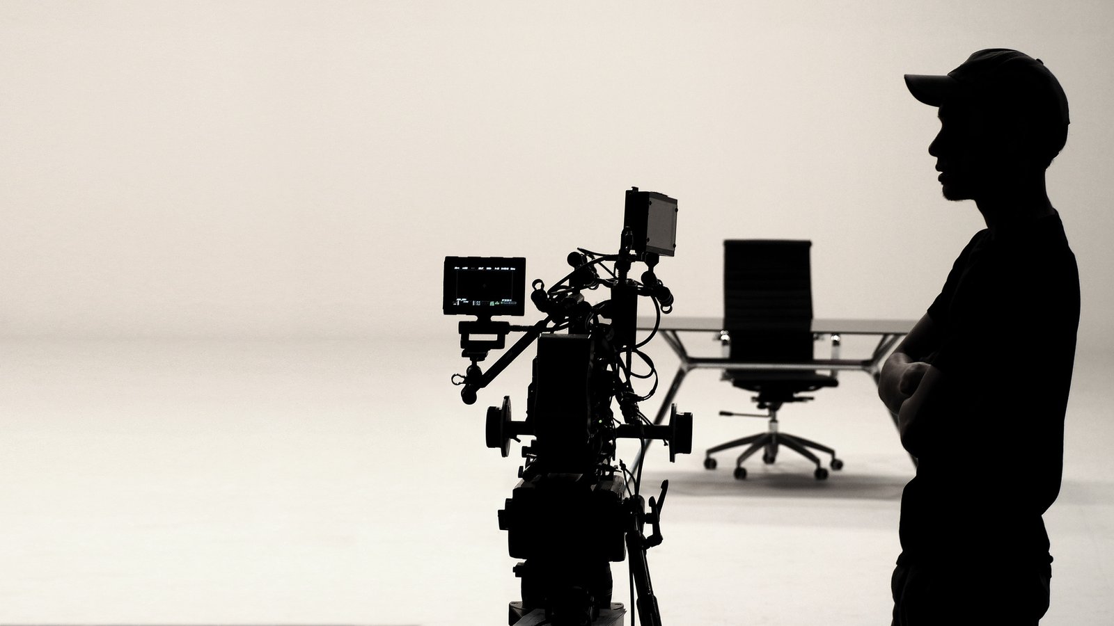 Silhouetted figure in a film studio — the future vision of Over Exposure Productions.